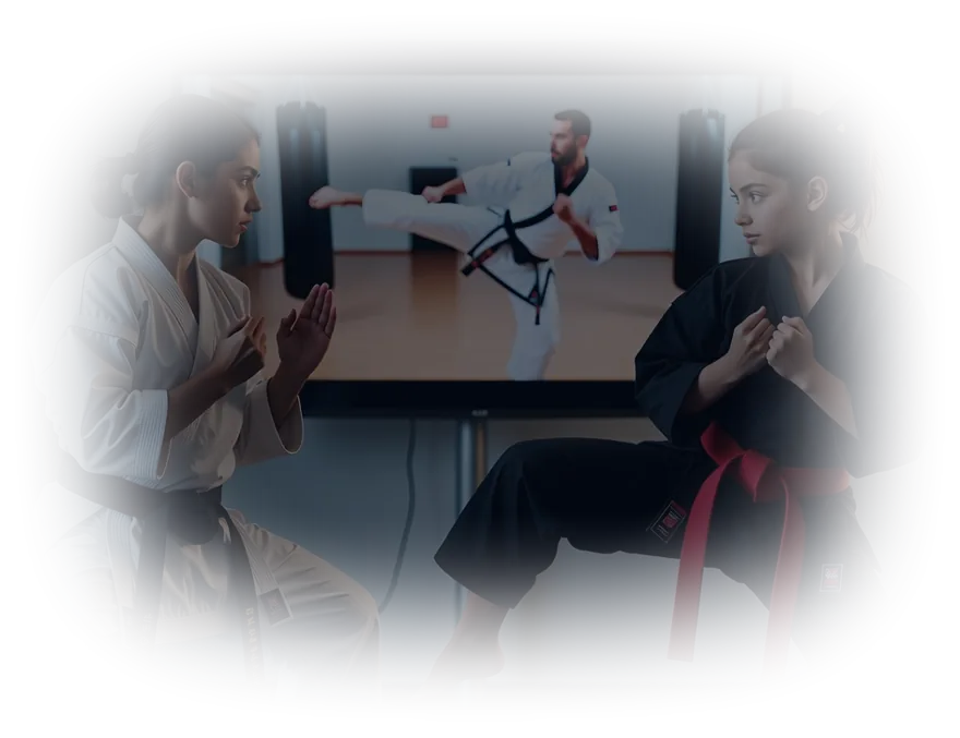Two students working through a form together while an instructor's reference video plays on the screen behind them